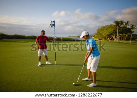 Couple having fun while playing golf.
