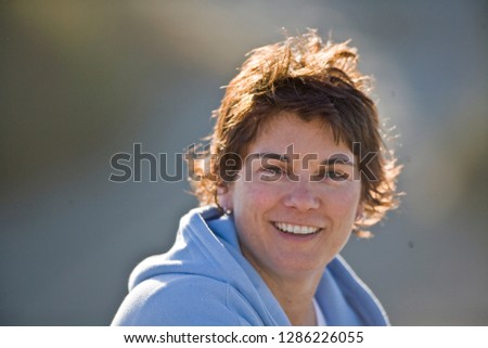 Portrait of a smiling mid-adult woman.