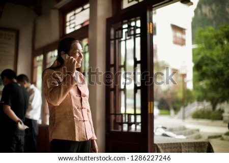 Chinese woman talking on her cell phone.