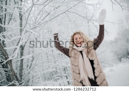 Photo of blonde woman on walk in winter forest