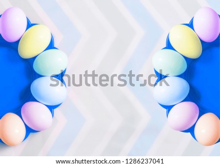 Easter colored eggs on pastel background. Top view