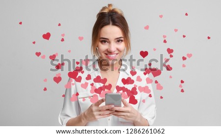 Valentine day concept, love message - hearts flying out smartphone in womans hands Royalty-Free Stock Photo #1286261062