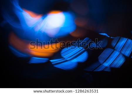 Abstract photo of blurred light sources in orange and blue colors