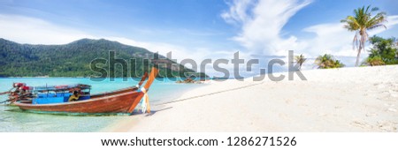 Empty sunny Koh Lipe Bulow Beach panorama with long tail wooden boats Royalty-Free Stock Photo #1286271526