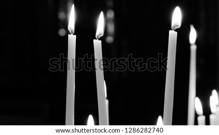 black and white picture of candles in a church in valkenburg the netherlands