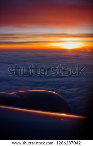 Sunrise from an airplane above the clouds.