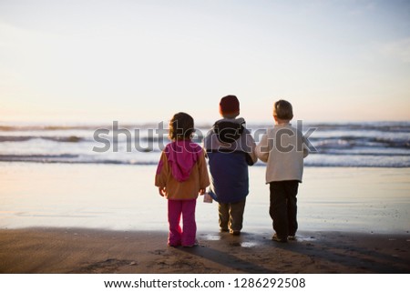 Children standing on beach, El Salvador.