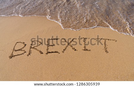 Handwrite text Brexit on sand coastline and foam wave. On referendum, voted to exit United Kingdom from European Union - knows as Brexit, which is expected on March 29, 2019 Royalty-Free Stock Photo #1286305939