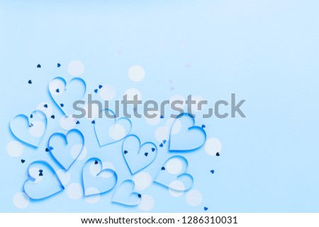 Valentine's day greeting card with beautiful pure blue hearts and confetti. Lovely Happy Valentine's day minimal concept. top view, flat lay.