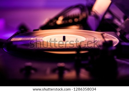 DJ Vinyl disc turntable, purple light background