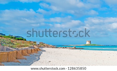 La Pelosa beach with its famous Aragonese tower Royalty-Free Stock Photo #128635850