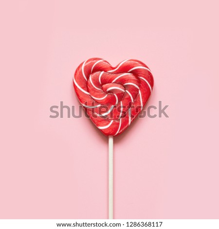 Valentine's card. Lollipops candy as heart on pink background. Funny concept.