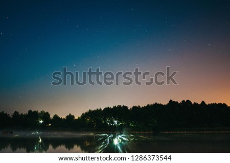 night landscape. night sky and reflections in the lake. cold evening
