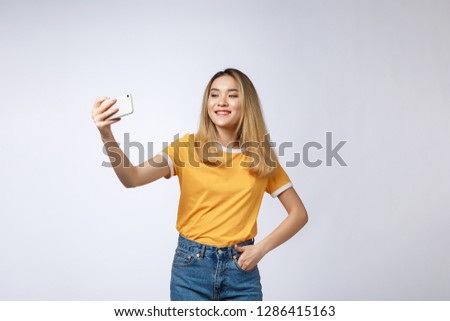 Close-up of young Asian beautiful woman taking selfie. Isolated white background.Beauty and Healthy Woman.