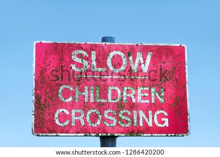 Caution children crossing road safety sign blue sky
