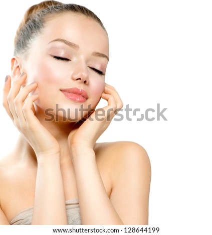 Beauty Girl Portrait. Beautiful Young Woman isolated on White Background. Touching Her Face. Fresh Clean Skin.