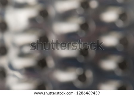 Defocused Metal Grid with round cell close-up Bokeh. Abstract Grater Pattern Silver Diamond Texture Background