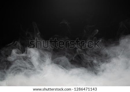 dense smoke on black background Royalty-Free Stock Photo #1286471143