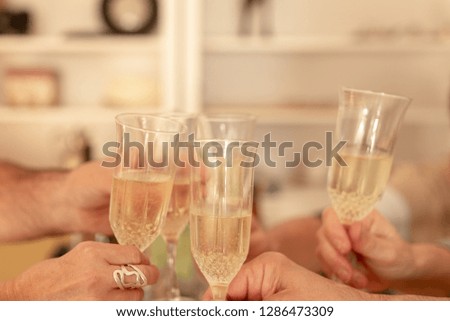 hands clinking champagne glasses 