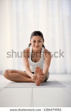 Portrait of a young woman stretching.