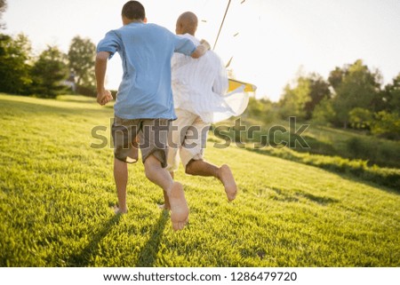 Father and son with a toy sailboat