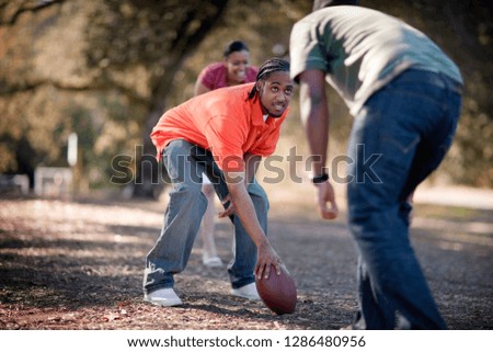 People playing American Football in park