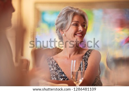 Couple sitting down at an upscale restaurant.