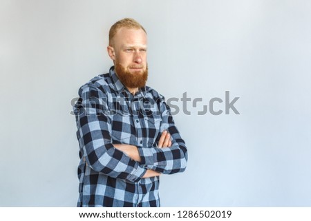 Red hair mature man standing isolated on grey wall crossed arms looking forward pensive