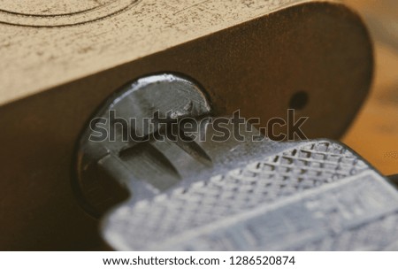 Macro image of key stuck in lock, open lock with key in hole. Royalty high-quality free stock close up photo image of key in lock rusty