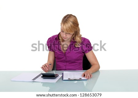 Woman using a calculator at work