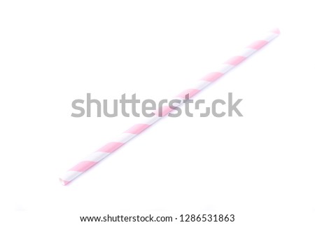 Closeup of drinking straw for party.  White with pink spiral. Top view of colorful disposable eco-friendly straw for summer cocktails. Paper coctail colorful straw on white  background, isolated.
