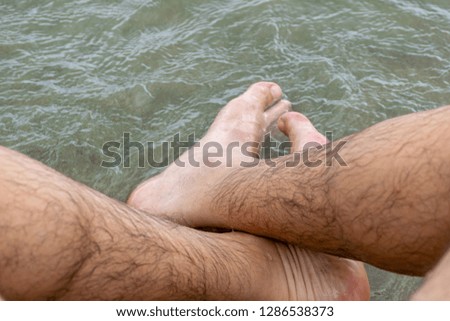close up of feet in sea water