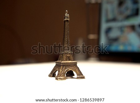 Mini statue of Eiffel tower. Background.