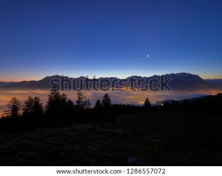 Nocturnal view of foggy Rhine valley against the blue night sky