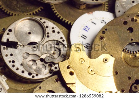 Old pocket watch faces backs gears and springs