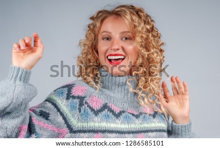 Happiness. Attractive happy student woman with curly hair dressed in warm sweater