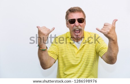 Portrait of senior old man exited funky funny comic guy gesture his hands as a rocker. Elderly nerd grandfather rock music lover fan, happy cheerful face lifestyle after retirement concept