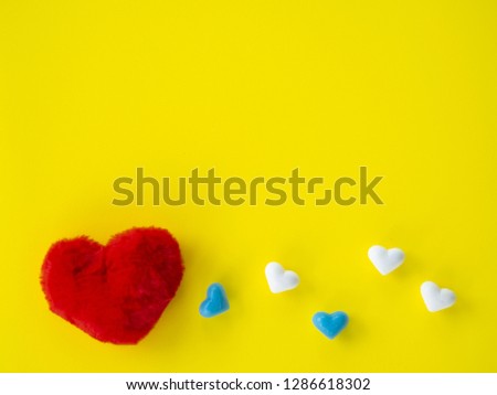 blue hearts shape and white hearts shape and big red heart shape in left side put on yellow background have free space or copy space, image using for valentine ‘s day signs and lovely sweet concept