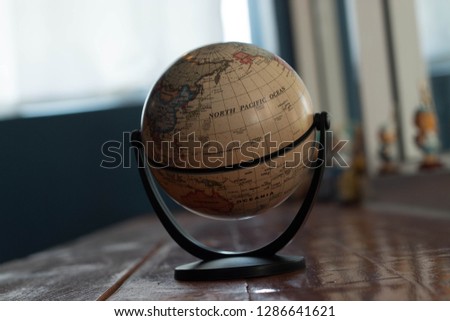 The globe picture is placed on the table.