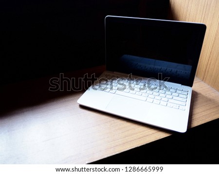 White laptop on wooden desk with space. Selective focus