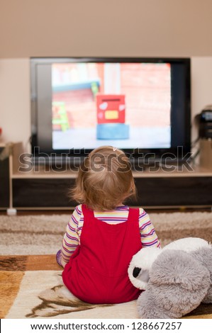 little girl watching television
