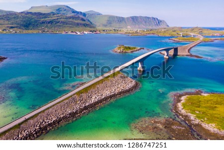 Norwegian scenic landscape on Lofoten archipelago. Road and bridge connecting the islands over the sea. National tourist route 10 Norway. Aerial view Royalty-Free Stock Photo #1286747251