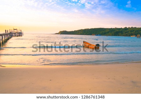 Beautiful tropical beach,Seascape in the sunset with a small boat against blue sky.