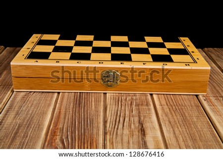 box of chess on a black background
