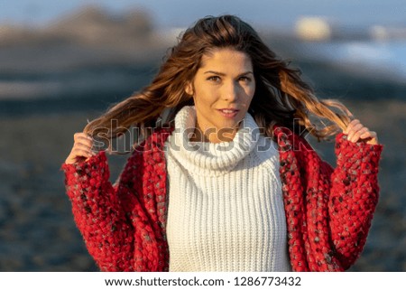 Happy Girl on the winter beach during a cold day