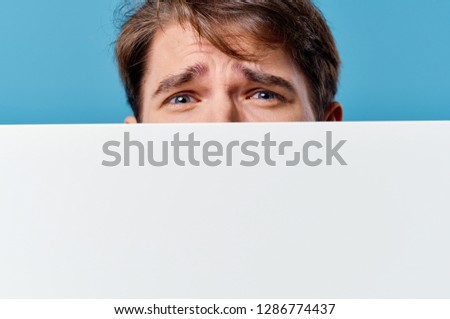 man behind poster mockup on blue isolated background                      