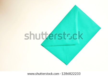 Closed vintage green envelope on white background with copy space