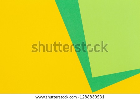 Geometric flat lay yellow and green color paper background