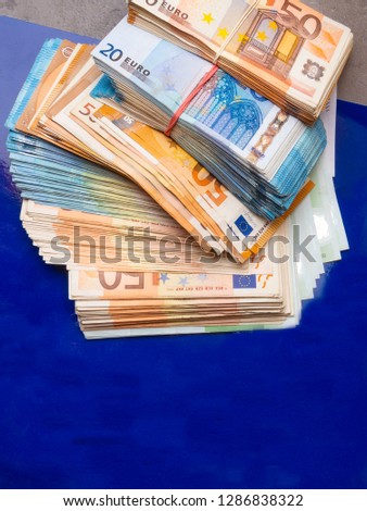 euro money banknotes, pile of money, cash, stack, new bills, isolated on blue background