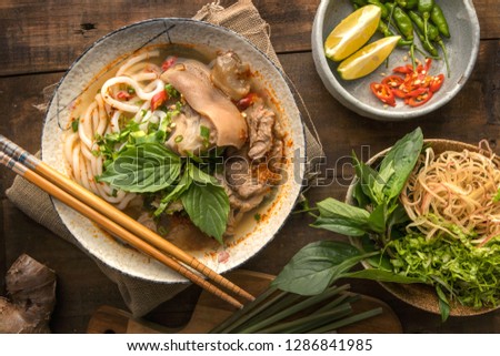 Bun Bo Hue, Bun Bo, Vietnamese beef noodle soup spicy. A bowl of beef & rice vermicelli soup, vietnamese noodle cuisine in Hue, Vietnam. Royalty-Free Stock Photo #1286841985